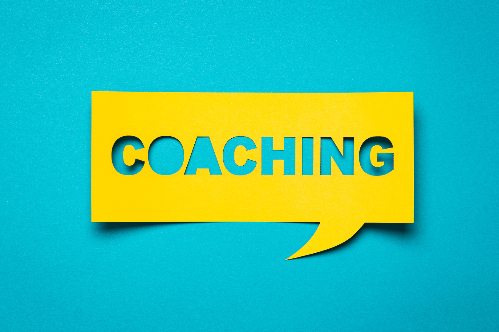 Yellow word bubble that says coaching