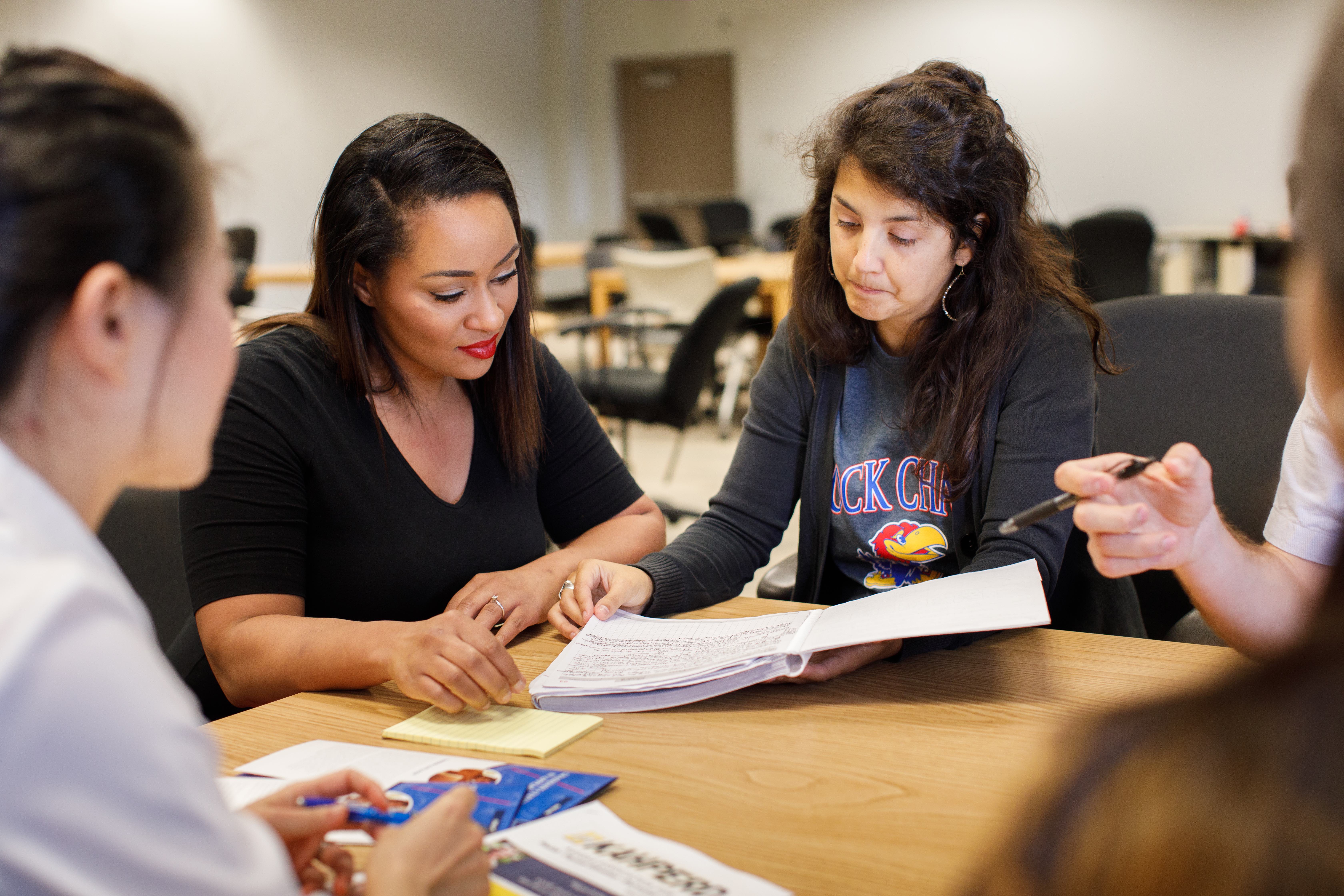 Edwards Campus students sharing a book