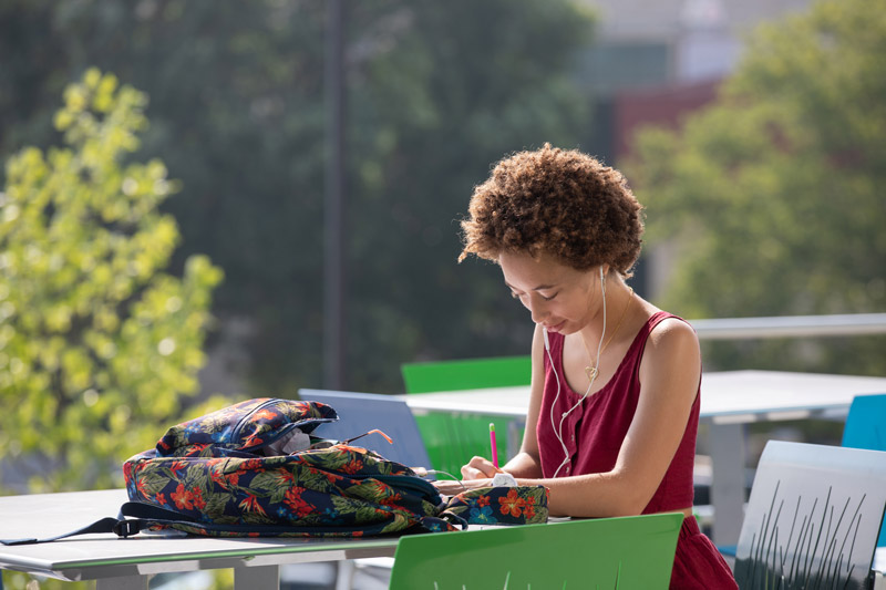 A student studies outside at the University of Kansas campus