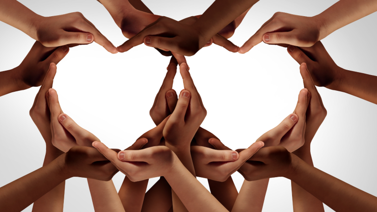 many hands of varying skin color and size forming two hearts